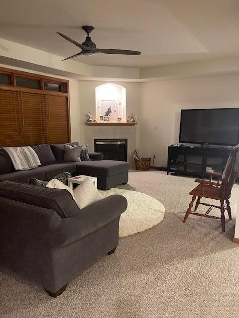 living room with carpet flooring and ceiling fan