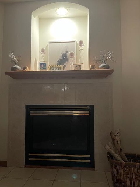 room details featuring a tiled fireplace and tile patterned floors