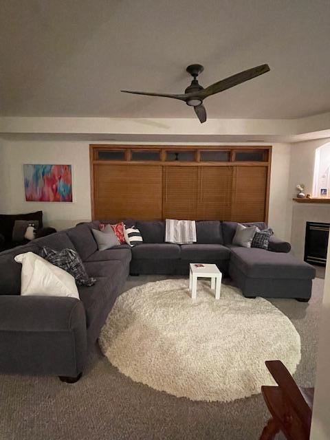 living room with carpet flooring and ceiling fan