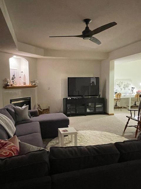 living room featuring carpet flooring and ceiling fan