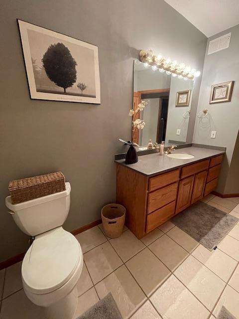 bathroom with vanity, tile patterned floors, and toilet