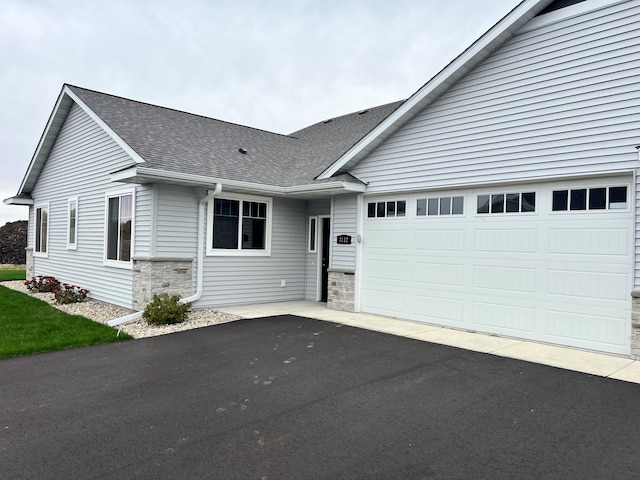 3112 Bassett Dr, Mankato, MN 56001 - single story home featuring driveway, roof with shingles, an attached garage, and stone siding
