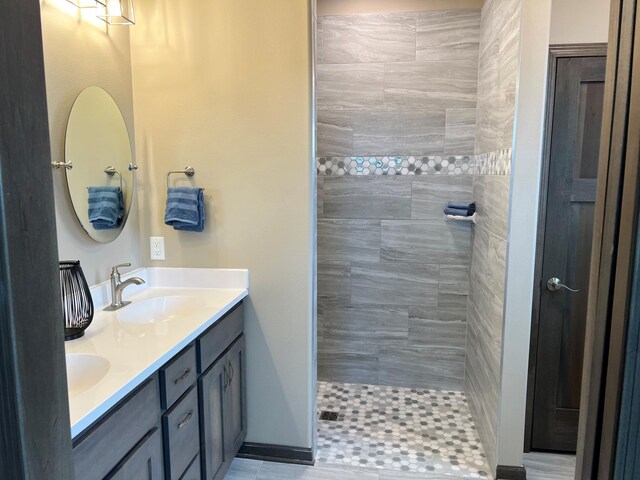 3112 Bassett Dr, Mankato, MN 56001 - full bathroom with tiled shower, double vanity, and a sink