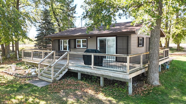 rear view of property featuring a deck