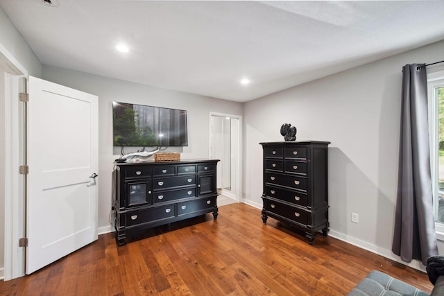 bedroom featuring baseboards, wood finished floors, and recessed lighting