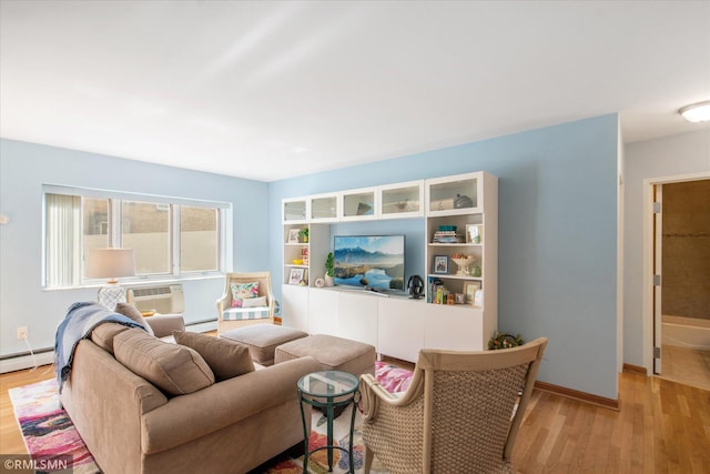 living room featuring baseboard heating and light hardwood / wood-style flooring