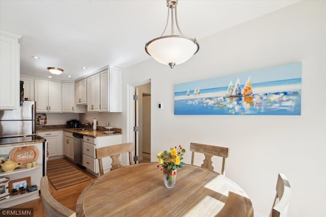 dining room featuring sink and wood-type flooring