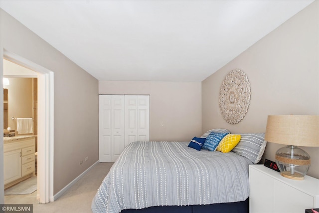2928 Dean Pkwy Unit 2J, Minneapolis, MN 55416 - bedroom with connected bathroom, a closet, light carpet, and baseboards