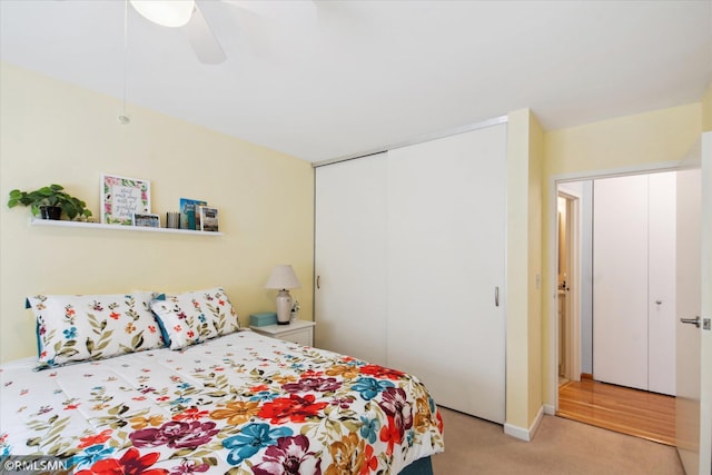 carpeted bedroom with a closet and ceiling fan