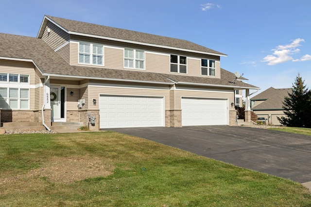 view of front facade with a garage and a front lawn