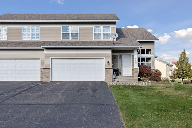 view of front of home with a front yard and a garage