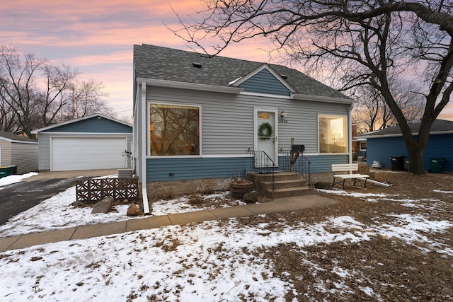 view of front of house featuring a garage and an outdoor structure