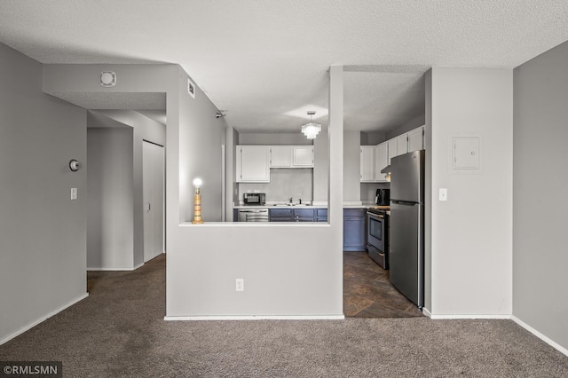 kitchen with white cabinetry, a textured ceiling, dark carpet, sink, and stainless steel appliances