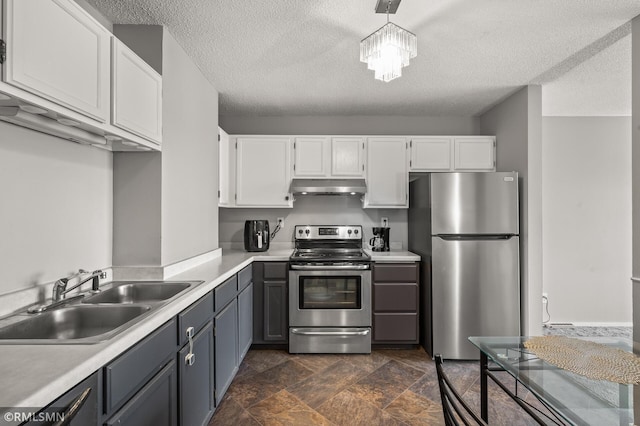 kitchen featuring white cabinetry, stainless steel appliances, sink, and pendant lighting