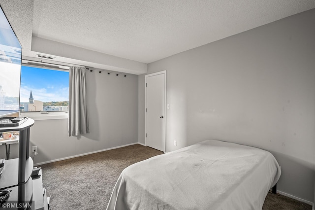 carpeted bedroom featuring a textured ceiling