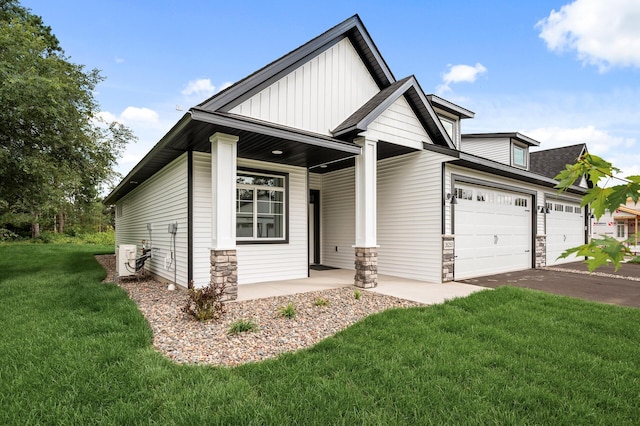 view of front of house featuring a garage, a front lawn, and covered porch