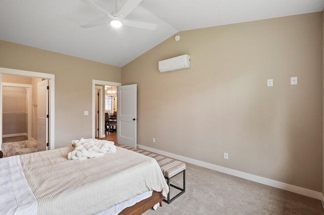 bedroom featuring lofted ceiling, a wall unit AC, ceiling fan, light carpet, and ensuite bathroom