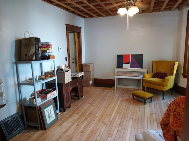 living area featuring visible vents, ceiling fan, and light wood-style flooring