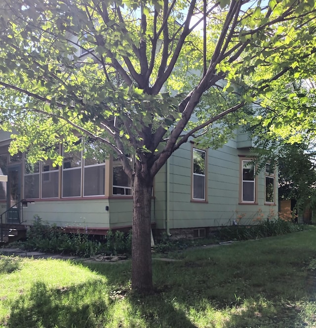 view of side of property featuring a sunroom