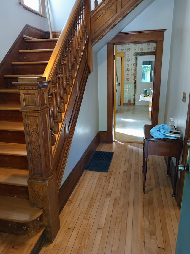 stairway featuring wood-type flooring and baseboards