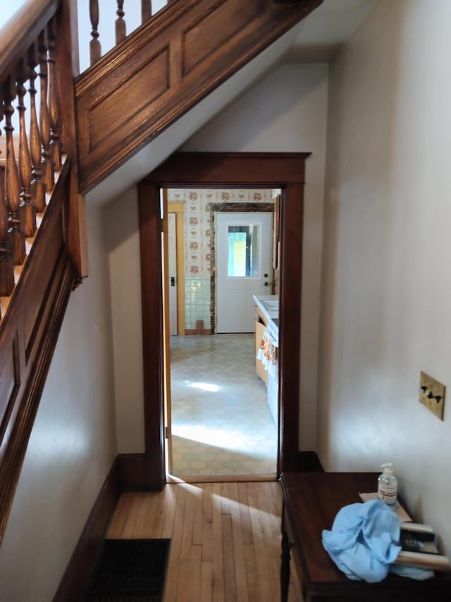 interior space featuring stairway, light wood finished floors, and baseboards