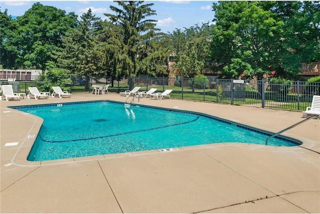 view of pool featuring a lawn and a patio