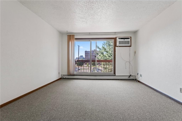 carpeted empty room with a wall mounted air conditioner, a baseboard radiator, and a textured ceiling