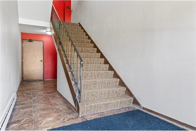 stairs featuring a baseboard radiator