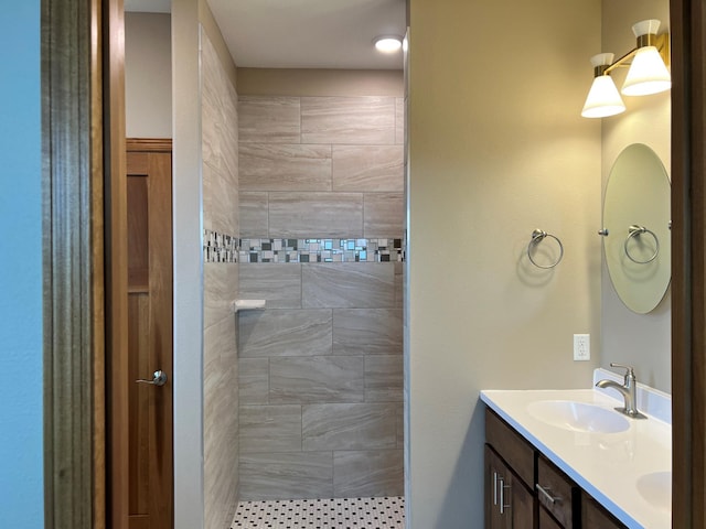 bathroom with vanity and tiled shower