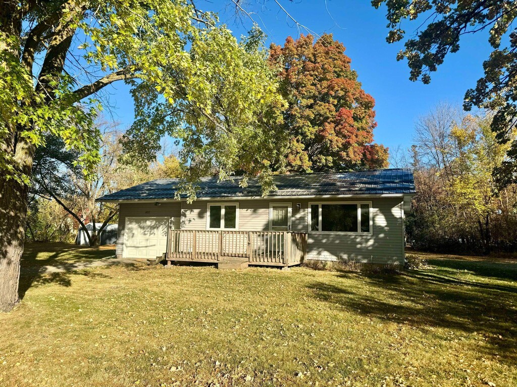 407 Pleasant Ave SE, Twin Valley, MN 56584 - rear view of house featuring a yard, a wooden deck, and a garage