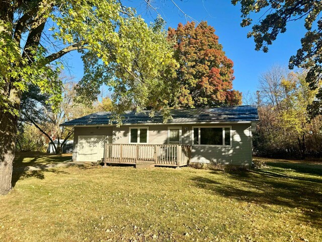 407 Pleasant Ave SE, Twin Valley, MN 56584 - rear view of house featuring a yard, a wooden deck, and a garage