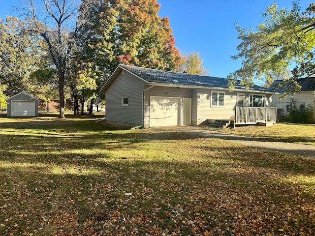 exterior space featuring a yard, a wooden deck, and a garage