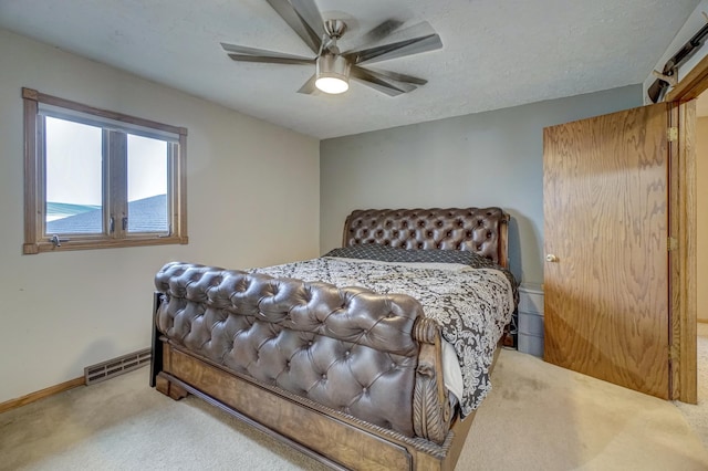 bedroom featuring baseboards, visible vents, carpet floors, ceiling fan, and a textured ceiling