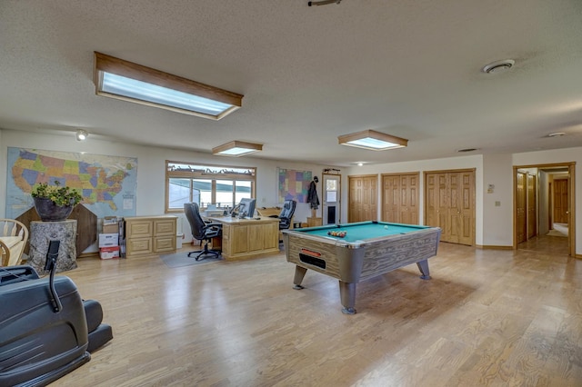 recreation room featuring pool table, visible vents, light wood finished floors, and a textured ceiling