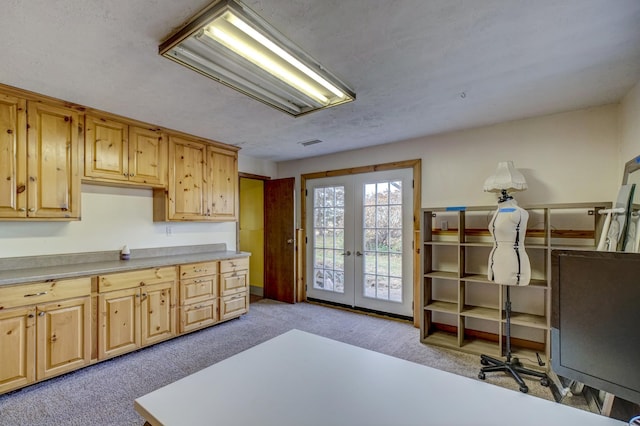 kitchen with visible vents, light carpet, light brown cabinetry, french doors, and light countertops