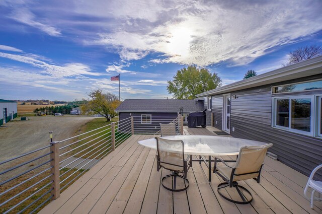 deck featuring outdoor dining area and area for grilling