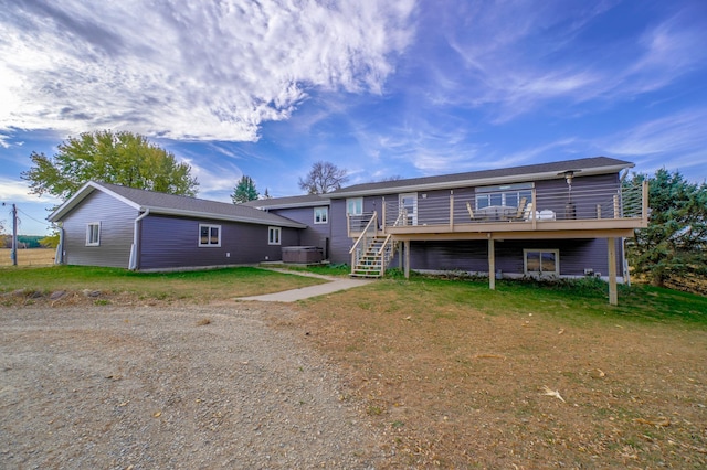 back of property with a lawn, central AC, and a deck