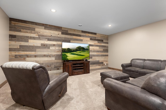 carpeted living room with wood walls