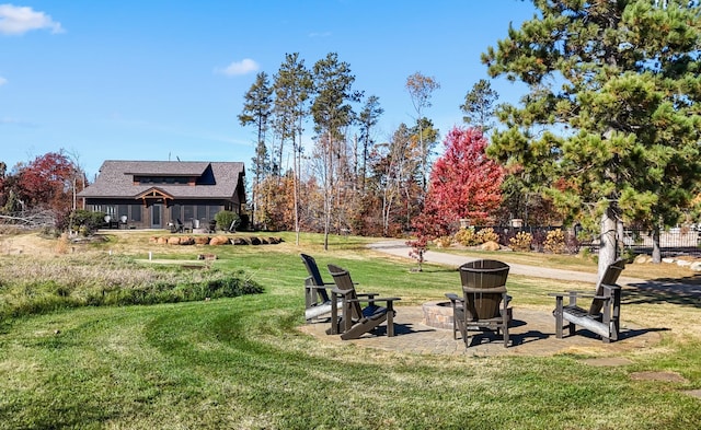 view of yard featuring a patio and an outdoor fire pit