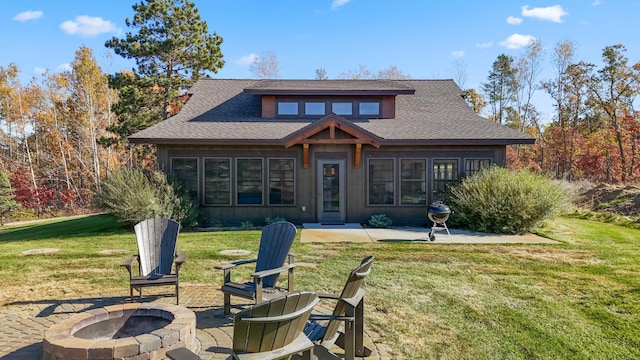 view of front of house with a patio, a front lawn, and a fire pit