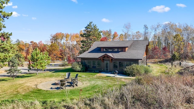 view of front of house with a front lawn and a fire pit