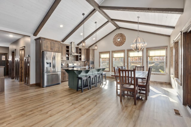 dining area with beamed ceiling, a chandelier, high vaulted ceiling, and light wood-type flooring