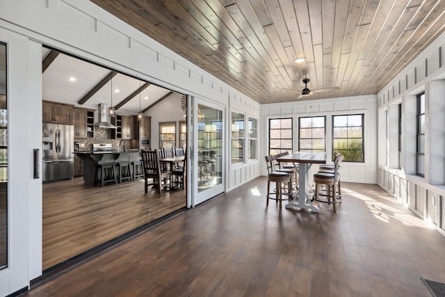 sunroom featuring lofted ceiling, sink, ceiling fan, and wooden ceiling