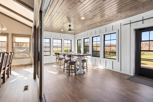 sunroom / solarium featuring lofted ceiling, ceiling fan, and wooden ceiling