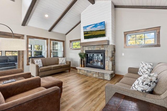 living room featuring light hardwood / wood-style floors, high vaulted ceiling, and a wealth of natural light