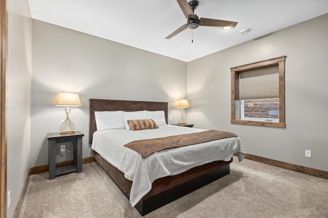 bedroom with ceiling fan and light carpet