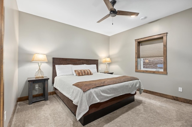 carpeted bedroom featuring baseboards and ceiling fan
