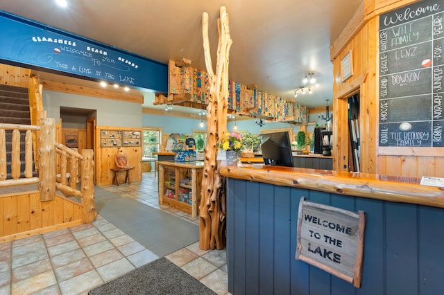 kitchen featuring wood walls and blue cabinets