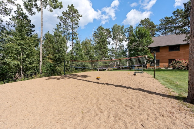 surrounding community with a yard and volleyball court