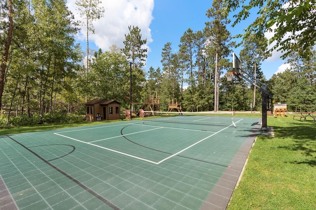 view of sport court with a yard and a playground